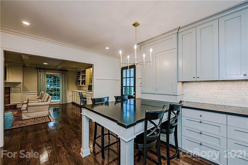 2831 Wickersham Road Charlotte, NC 28211 - Photo 22 of 47 a kitchen with a table chairs stove and cabinets