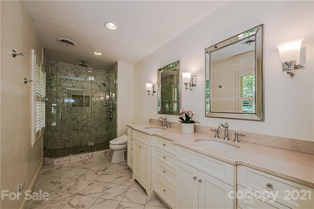 2831 Wickersham Road Charlotte, NC 28211 - Photo 32 of 47 a bathroom with a double vanity sink mirror double shower and a toilet