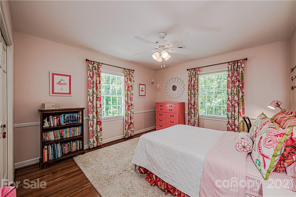 2831 Wickersham Road Charlotte, NC 28211 - Photo 33 of 47 a bedroom with a bed a dresser and a book shelf