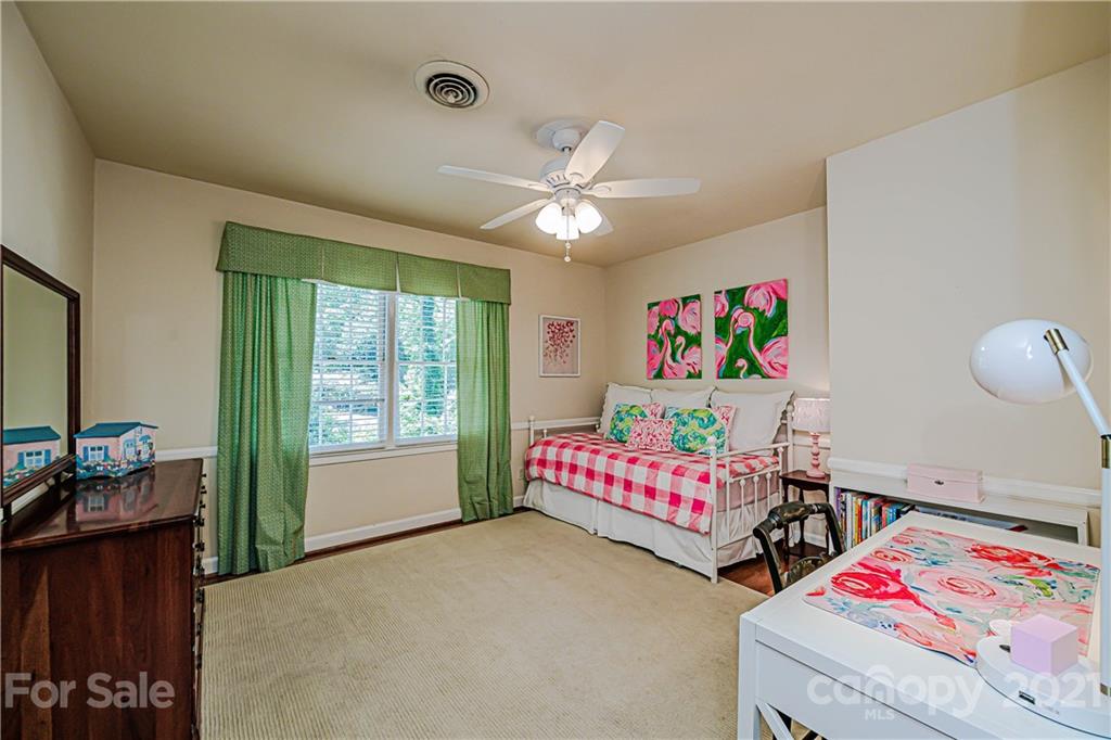 2831 Wickersham Road Charlotte, NC 28211 - Photo 34 of 47 a bedroom with furniture and a chandelier fan