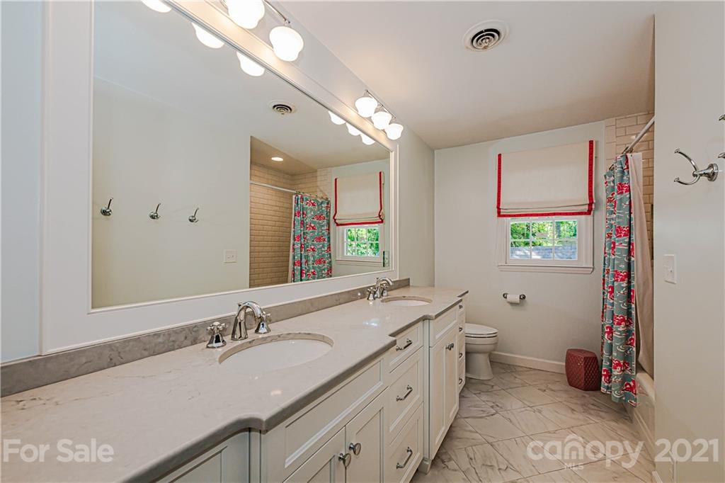 2831 Wickersham Road Charlotte, NC 28211 - Photo 35 of 47 a bathroom with a granite countertop sink mirror and a toilet