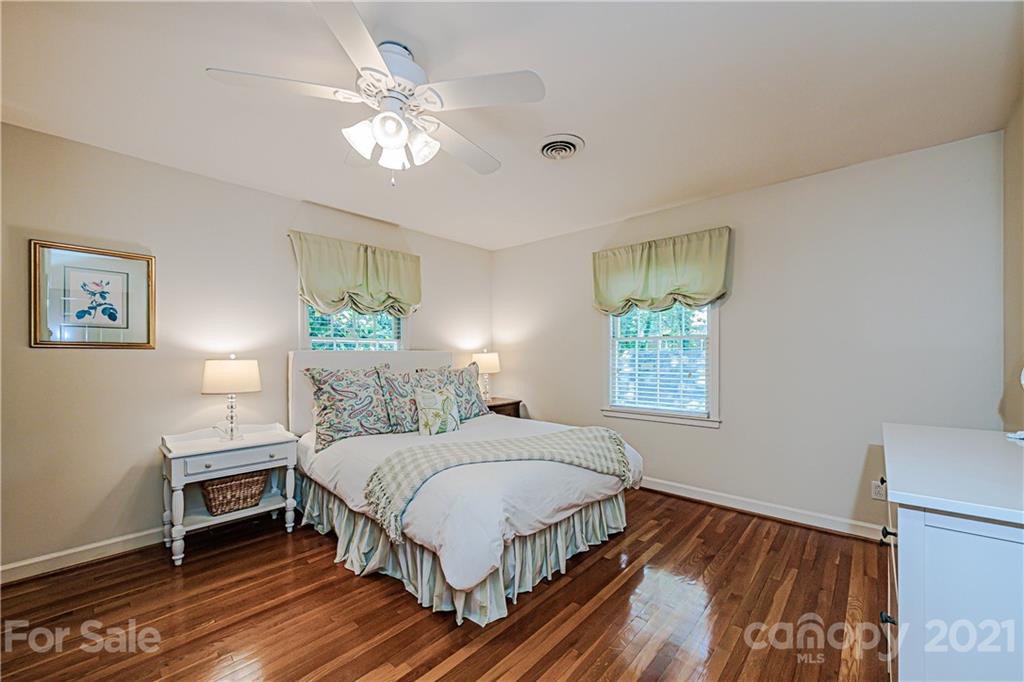 2831 Wickersham Road Charlotte, NC 28211 - Photo 36 of 47 a bedroom with a large bed chandelier and a window