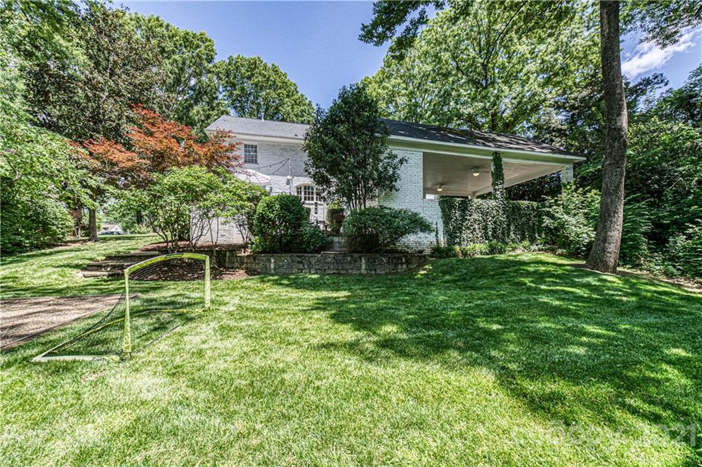 2831 Wickersham Road Charlotte, NC 28211 - Photo 44 of 47 a backyard of a house with plants and large trees