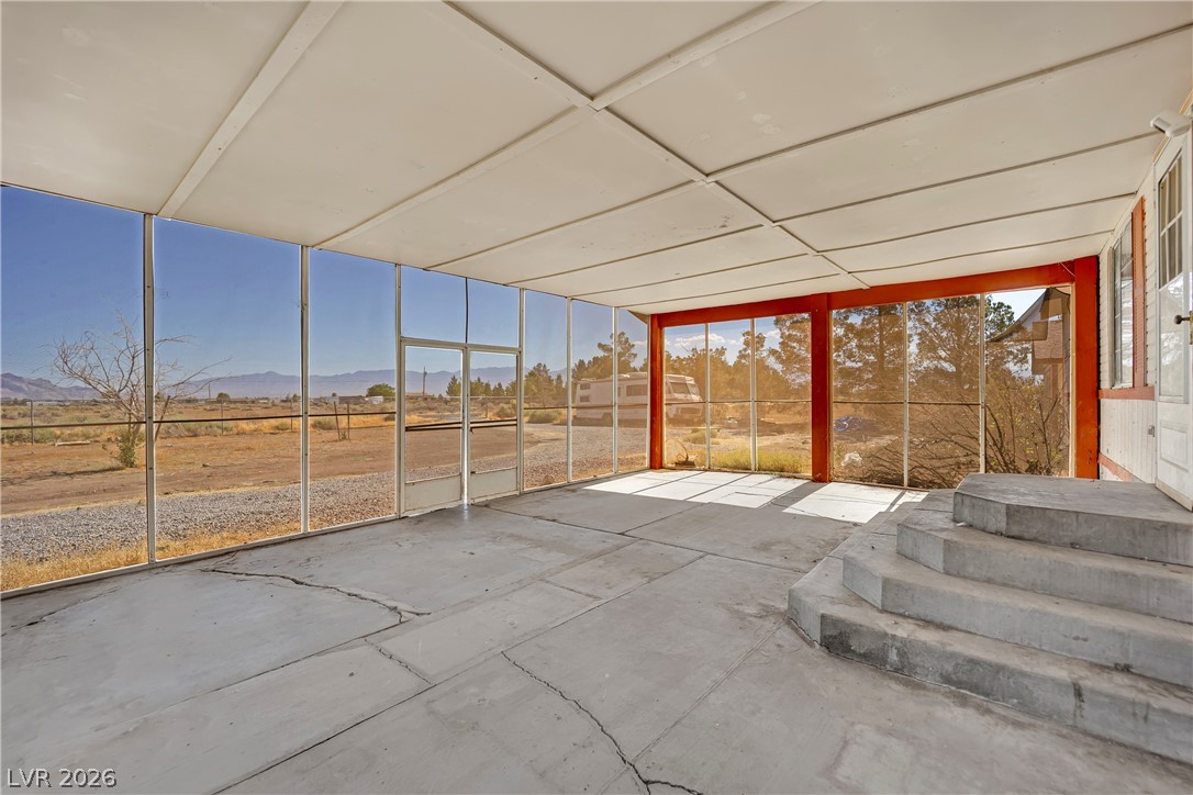 4361 Maple Road Pahrump, NV 89048 - Photo 32 of 46 A spacious screened-in porch offers panoramic desert and mountain views, extending living outdoors.