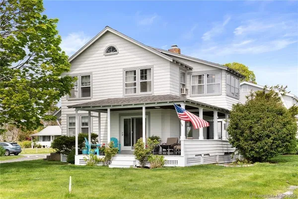 a front view of house with yard and outdoor seating