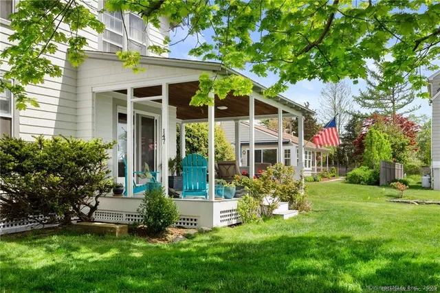 a view of a chairs and table in the back yard of the house