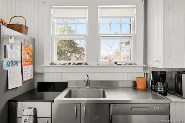 a kitchen with stainless steel appliances granite countertop a refrigerator and a stove