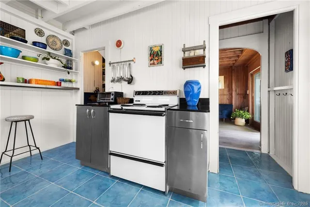 a kitchen with stainless steel appliances granite countertop a refrigerator and a stove