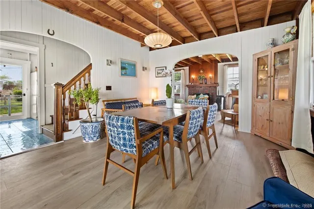a living room with furniture a wooden floor and a window