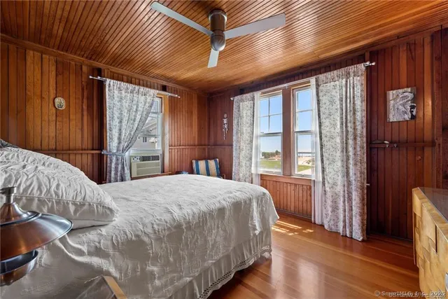 a bedroom with a bed and a large window