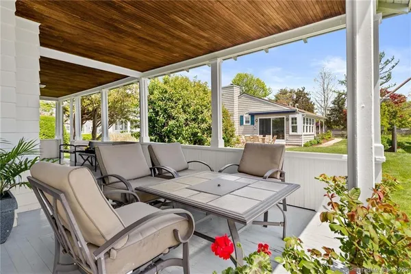 a view of a chairs and table in the back yard of the house
