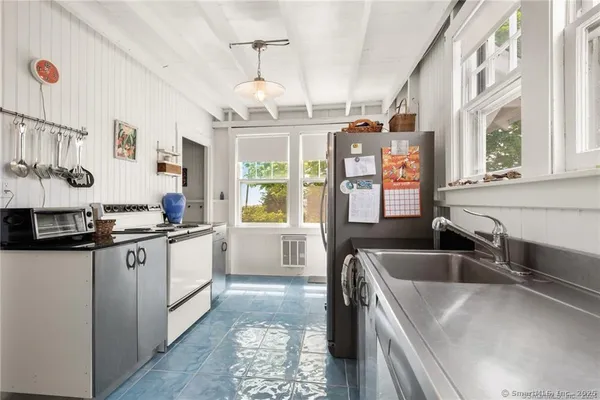 a kitchen with stainless steel appliances a refrigerator and a stove top oven