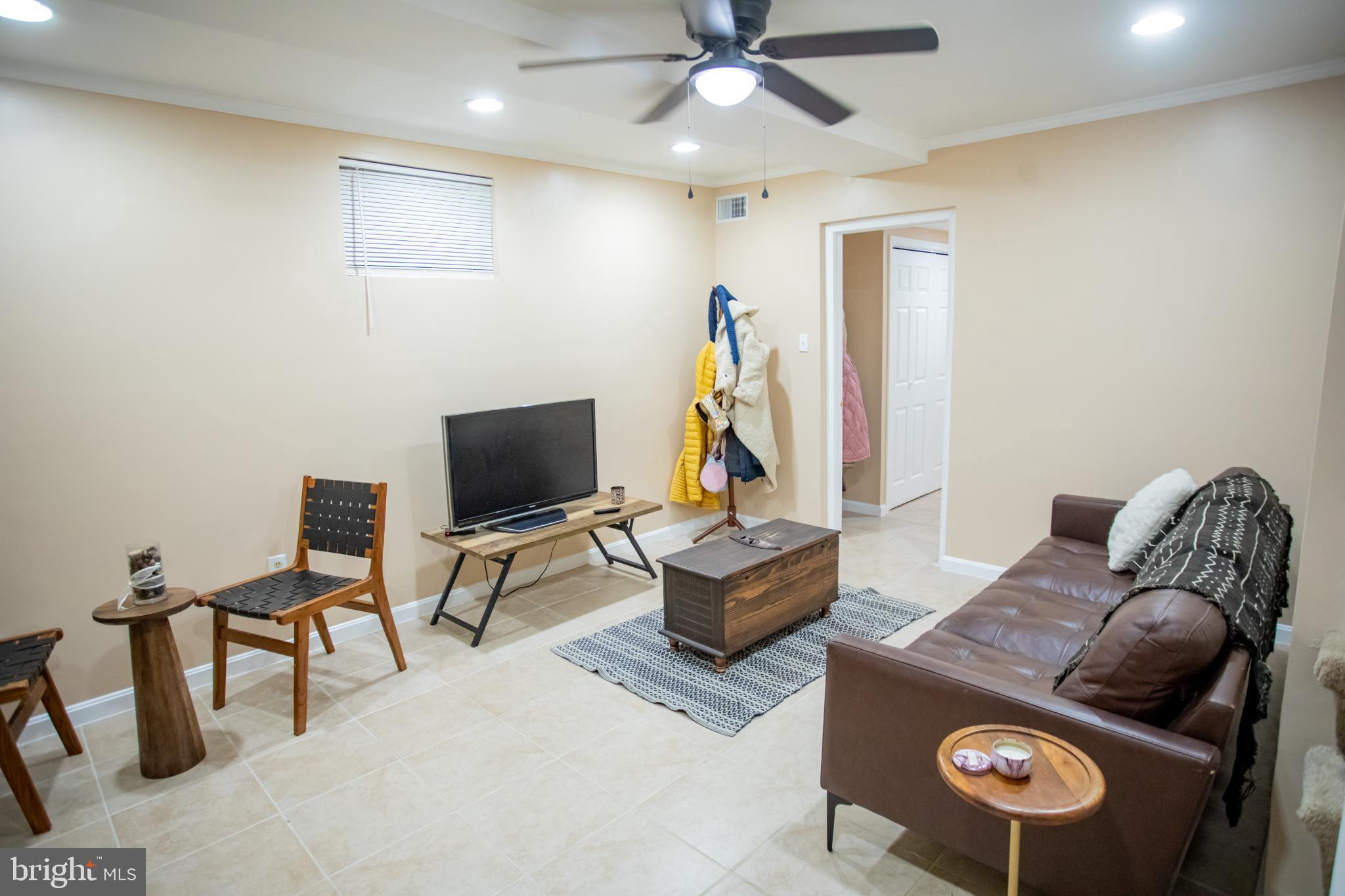 3913 Q Street Southeast Washington, DC 20020 - Photo 13 of 31 a living room with furniture and a flat screen tv