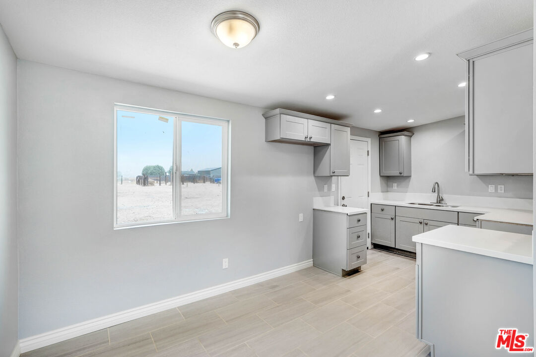 35233 Birch Road Barstow, CA 92311 - Photo 8 of 13 a kitchen with a sink window and stainless steel appliances
