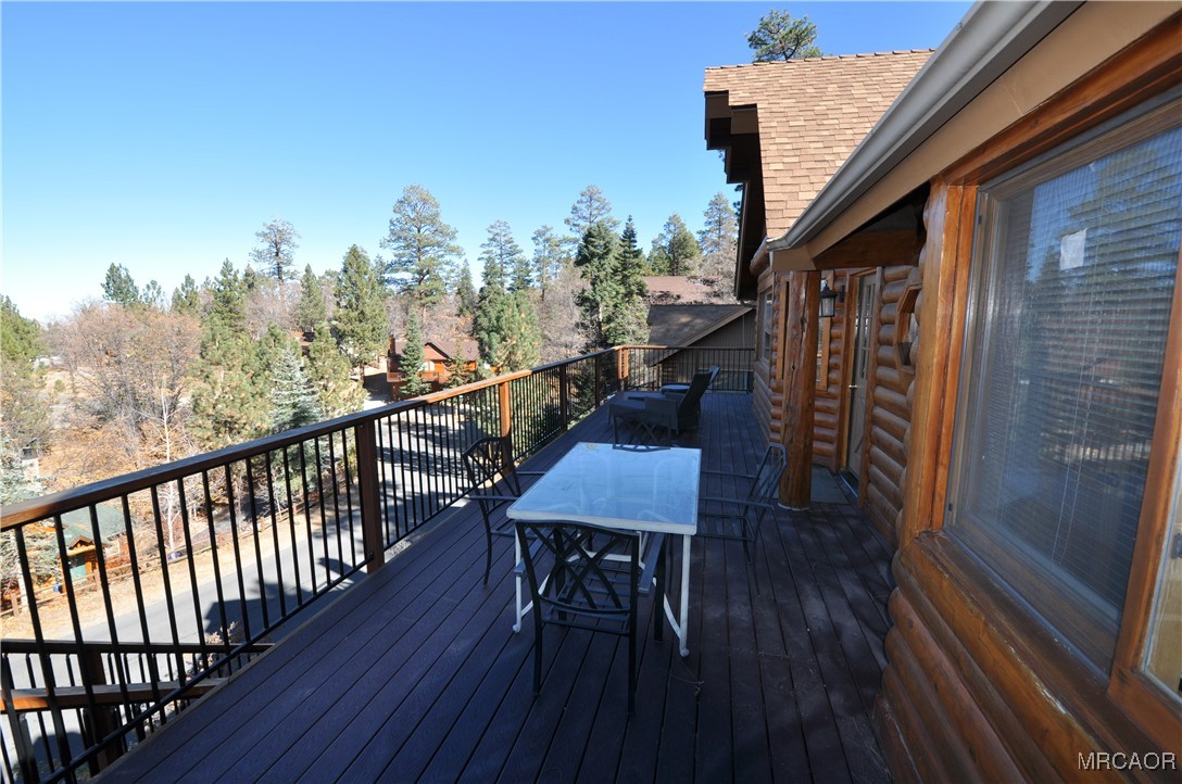 1419 Klamath Road Big Bear City, CA 92314 - Photo 15 of 31 a view of a balcony with furniture and wooden floor