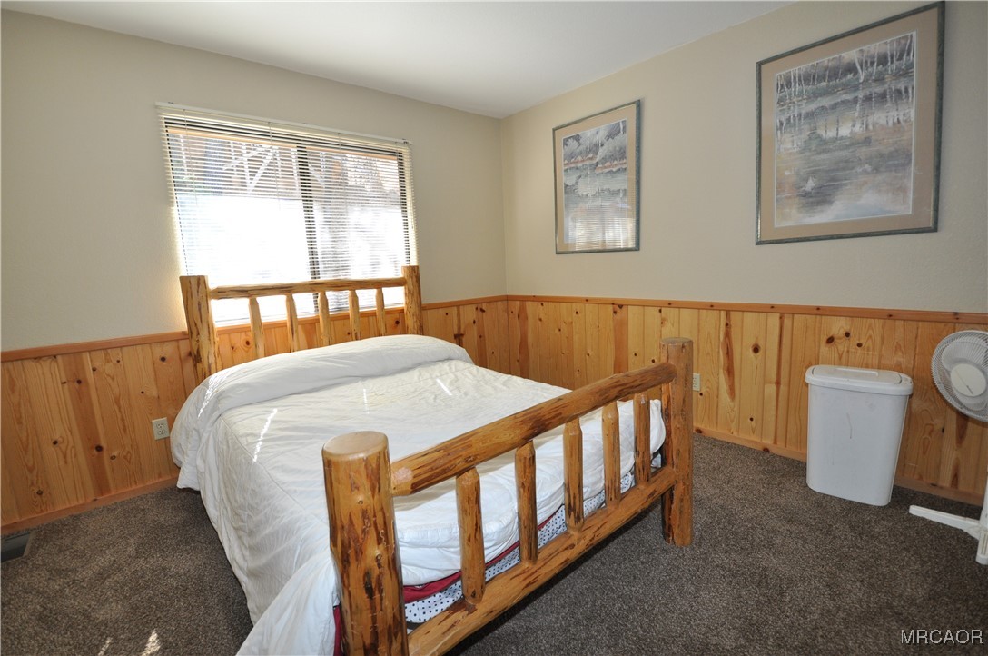 1419 Klamath Road Big Bear City, CA 92314 - Photo 5 of 31 a bed sitting in a bedroom next to a window