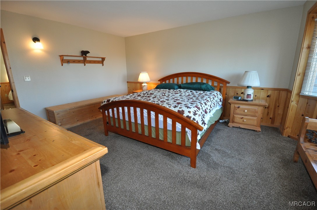 1419 Klamath Road Big Bear City, CA 92314 - Photo 6 of 31 a bedroom with a bed and a table