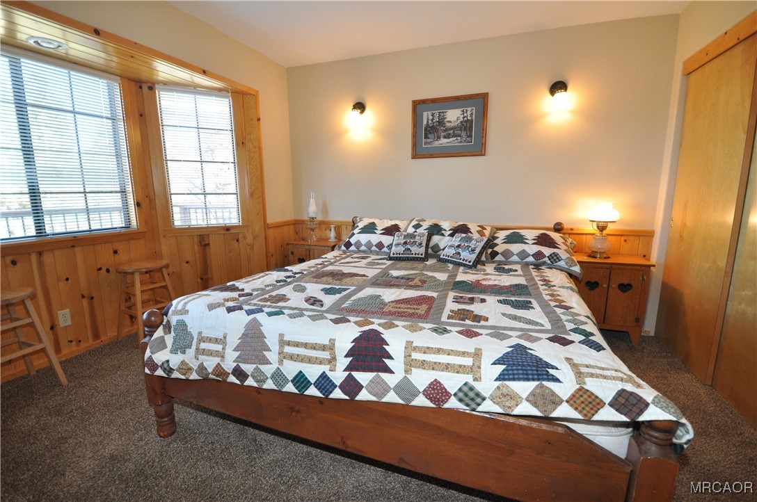1419 Klamath Road Big Bear City, CA 92314 - Photo 10 of 31 a bed sitting in a bedroom next to a window