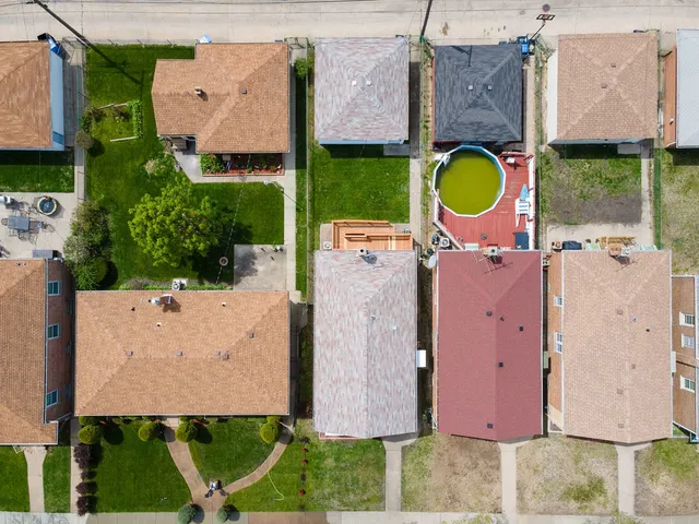an aerial view of a house with a swimming pool