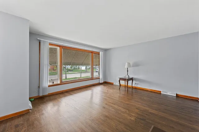 a view of room with hardwood floor and a window