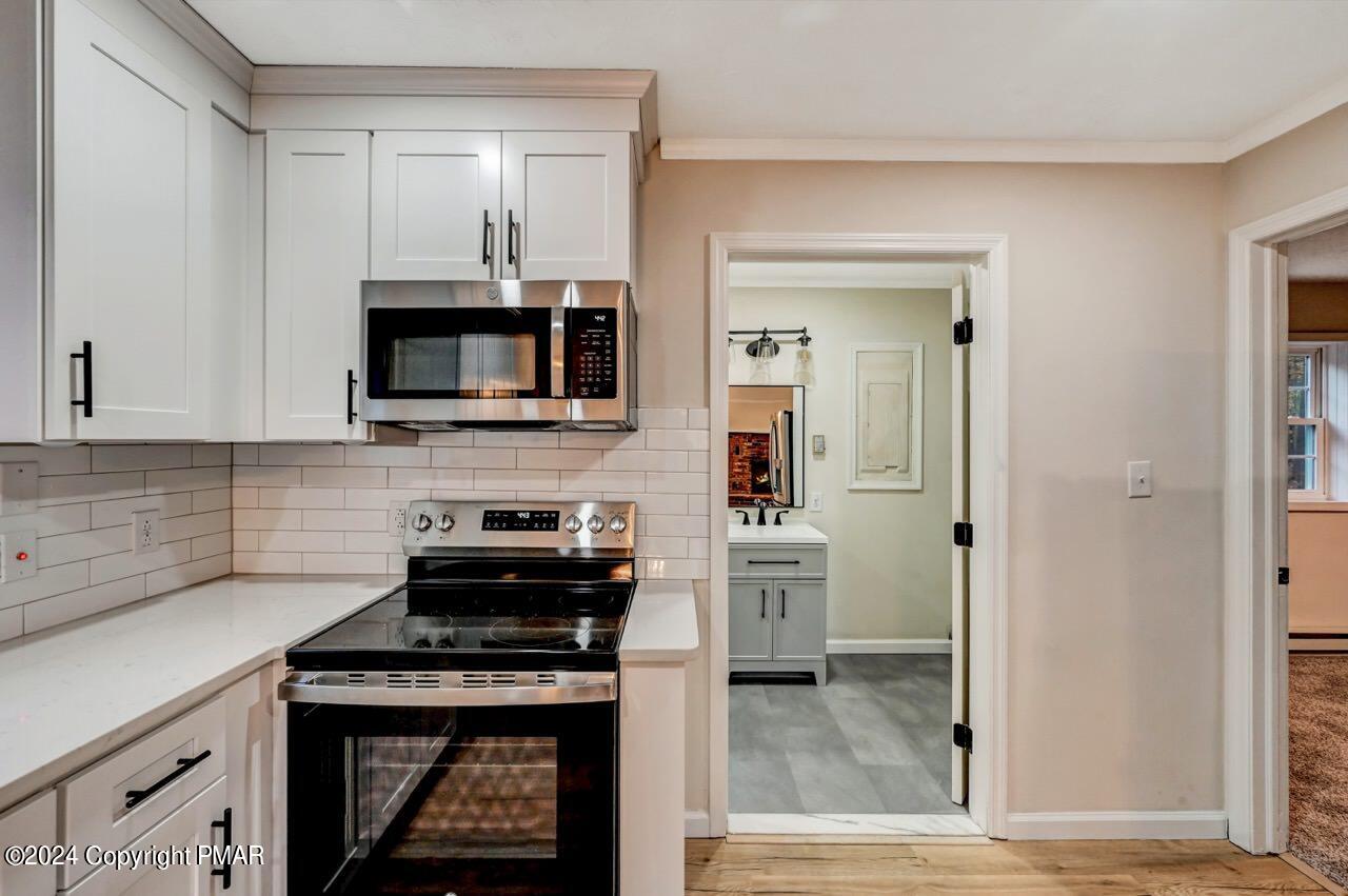 2228 Southport Drive Bushkill, PA 18324 - Photo 11 of 56 a kitchen with stainless steel appliances a stove and a microwave