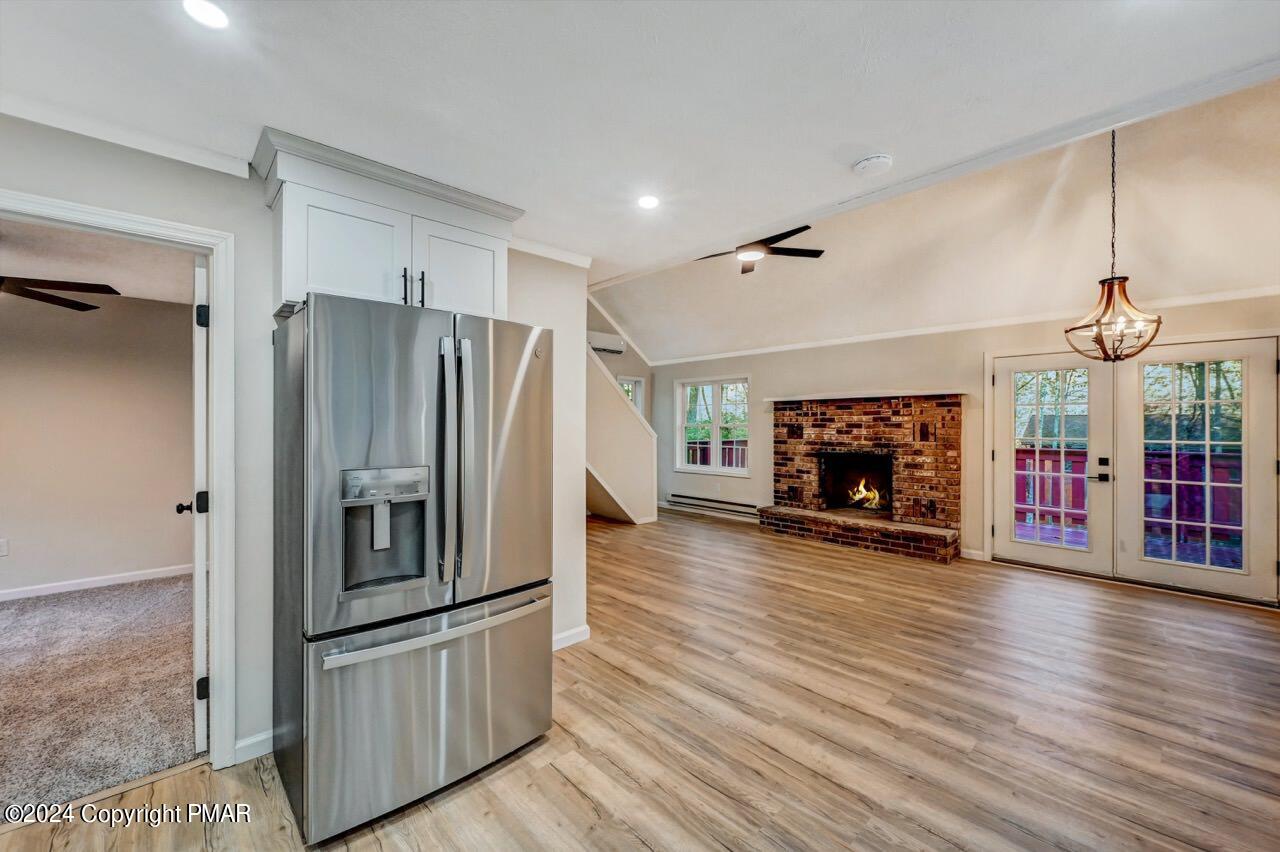 2228 Southport Drive Bushkill, PA 18324 - Photo 13 of 56 a kitchen with stainless steel appliances a refrigerator and a fireplace