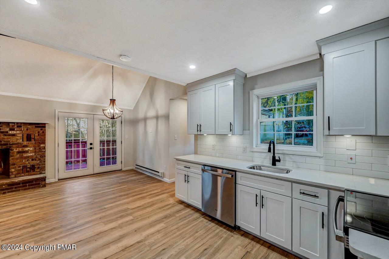 2228 Southport Drive Bushkill, PA 18324 - Photo 14 of 56 a kitchen with stainless steel appliances granite countertop a sink cabinets and wooden floor