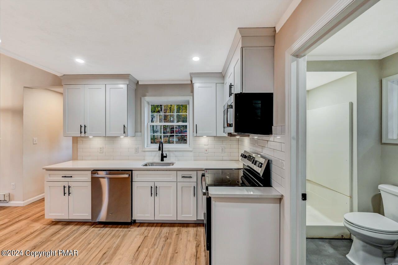2228 Southport Drive Bushkill, PA 18324 - Photo 15 of 56 a kitchen with a sink a stove and cabinets