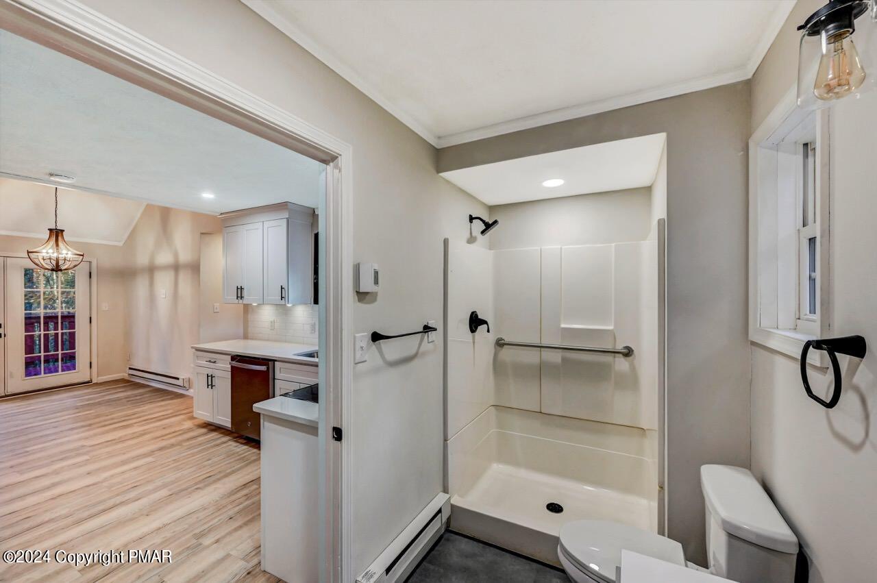 2228 Southport Drive Bushkill, PA 18324 - Photo 17 of 56 a bathroom with a glass shower door a sink and a mirror