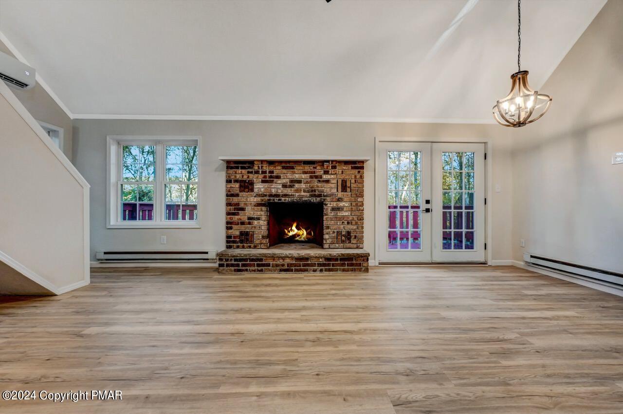 2228 Southport Drive Bushkill, PA 18324 - Photo 3 of 56 an empty room with windows and fireplace