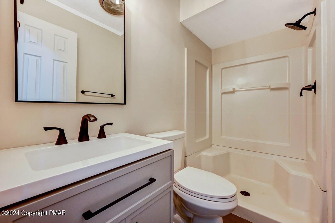 2228 Southport Drive Bushkill, PA 18324 - Photo 34 of 56 a bathroom with a sink a toilet and shower