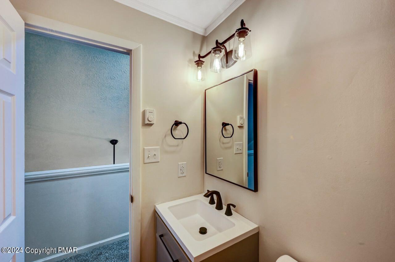 2228 Southport Drive Bushkill, PA 18324 - Photo 37 of 56 a bathroom with a sink a mirror and shower