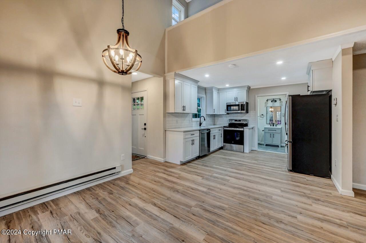 2228 Southport Drive Bushkill, PA 18324 - Photo 6 of 56 a view of kitchen with stainless steel appliances granite countertop a refrigerator and a stove top oven