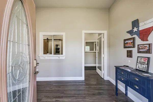 a view of a livingroom with wooden floor and cabinet