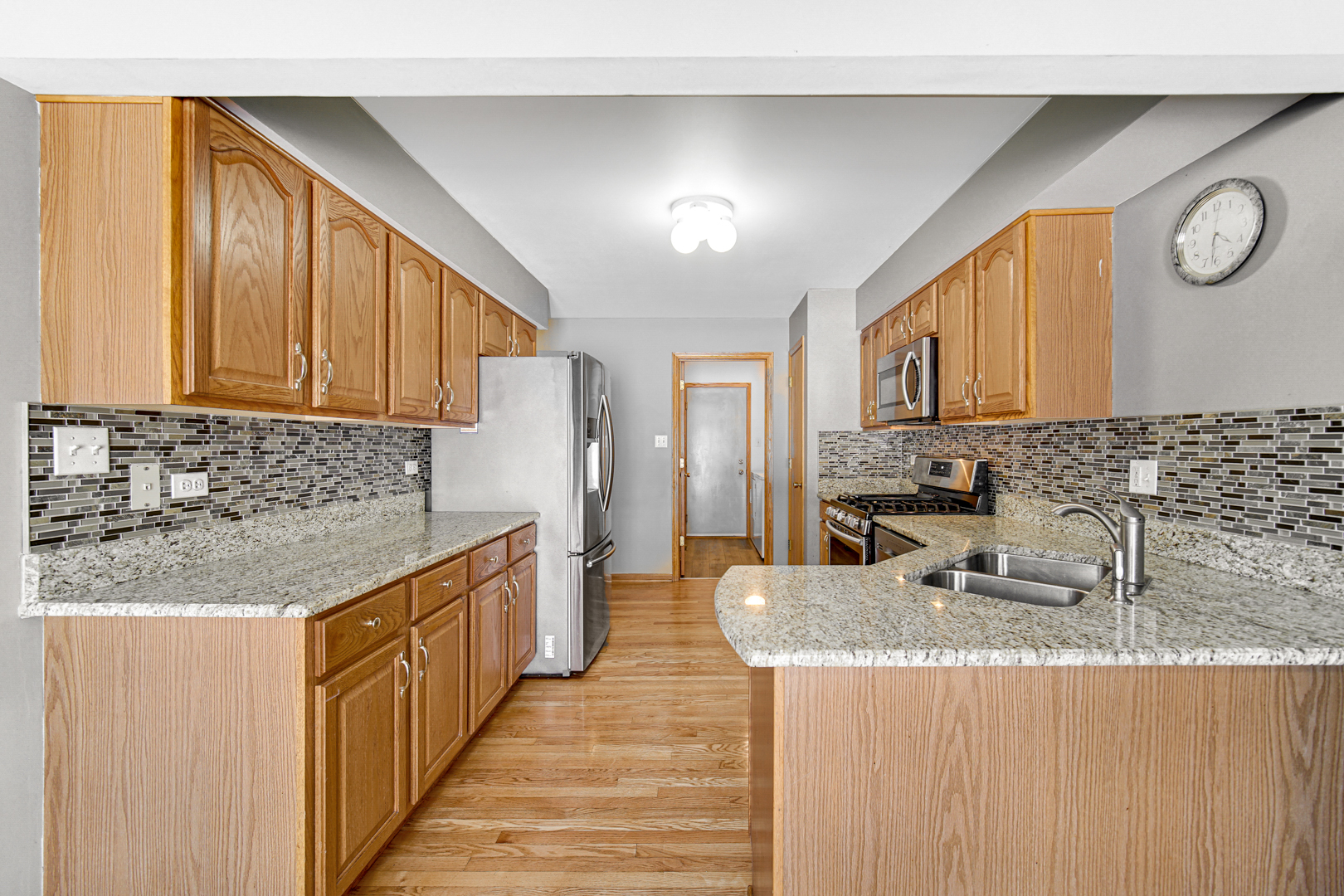 11837 Somerset Road Orland Park, IL 60467 - Photo 11 of 26 a kitchen with stainless steel appliances granite countertop a sink and a stove