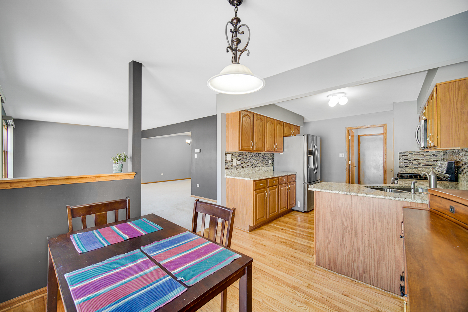 11837 Somerset Road Orland Park, IL 60467 - Photo 12 of 26 a very nice looking room with kitchen island furniture and a wooden floor