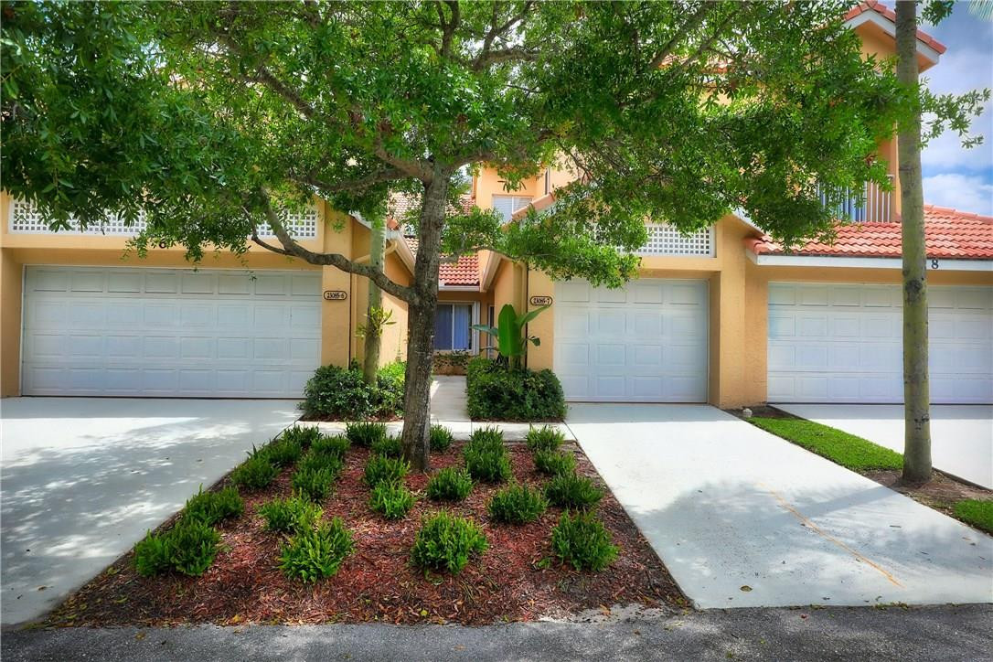 23085 Aqua View, Unit 7 Boca Raton, FL 33433 - Photo 21 of 22 a front view of a house with a yard and garage