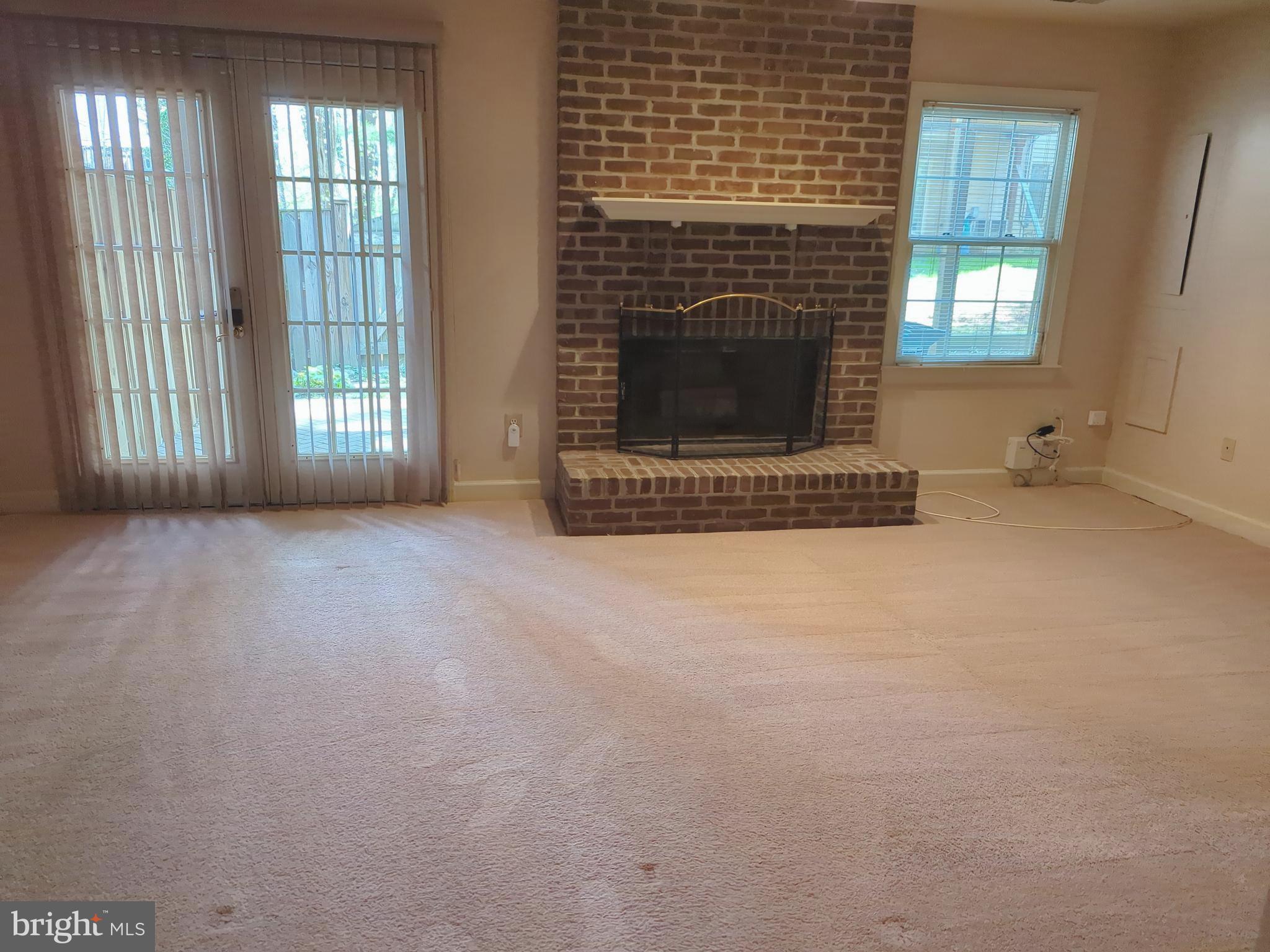 11223 Watermill Lane Silver Spring, MD 20902 - Photo 17 of 20 a view of livingroom with fireplace and window