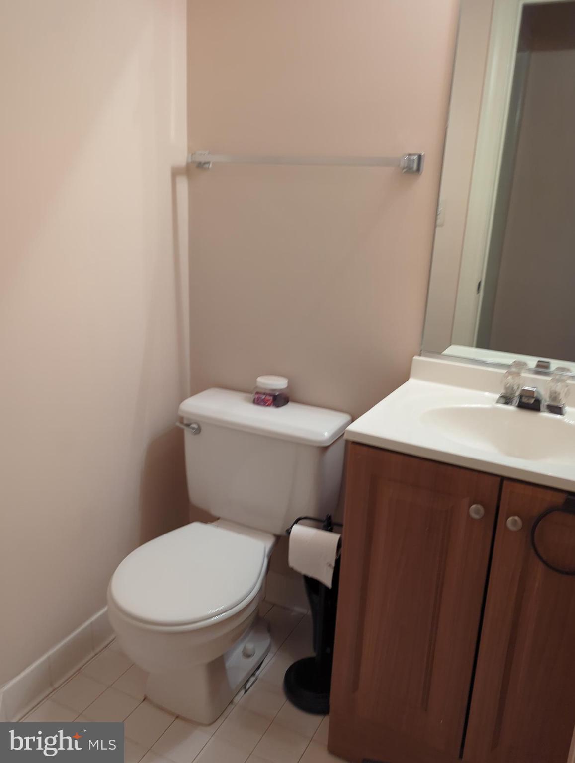 11223 Watermill Lane Silver Spring, MD 20902 - Photo 7 of 20 a white toilet sitting next to a bathroom sink