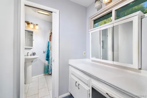 a view of a bathroom with a sink and a mirror