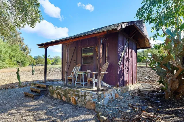 a view of house with backyard and outdoor seating