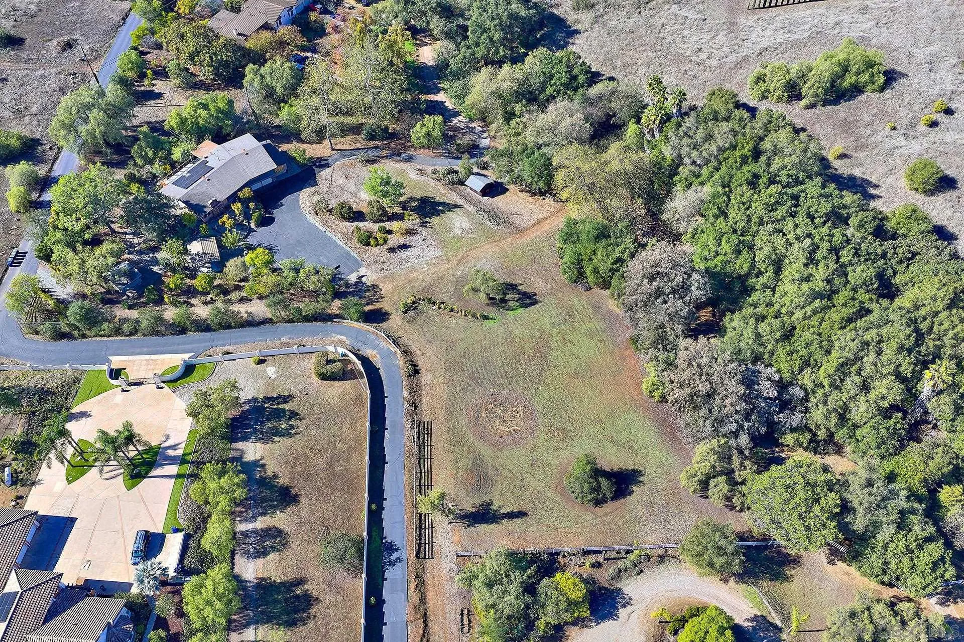 15260 Vali Hai Road Poway, CA 92064 - Photo 32 of 40 an aerial view of a house with a yard and parking spaces