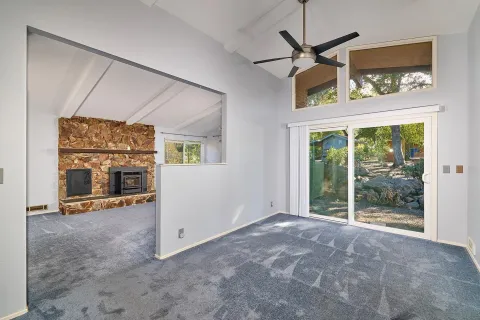 a view of a room with a large window and a fireplace