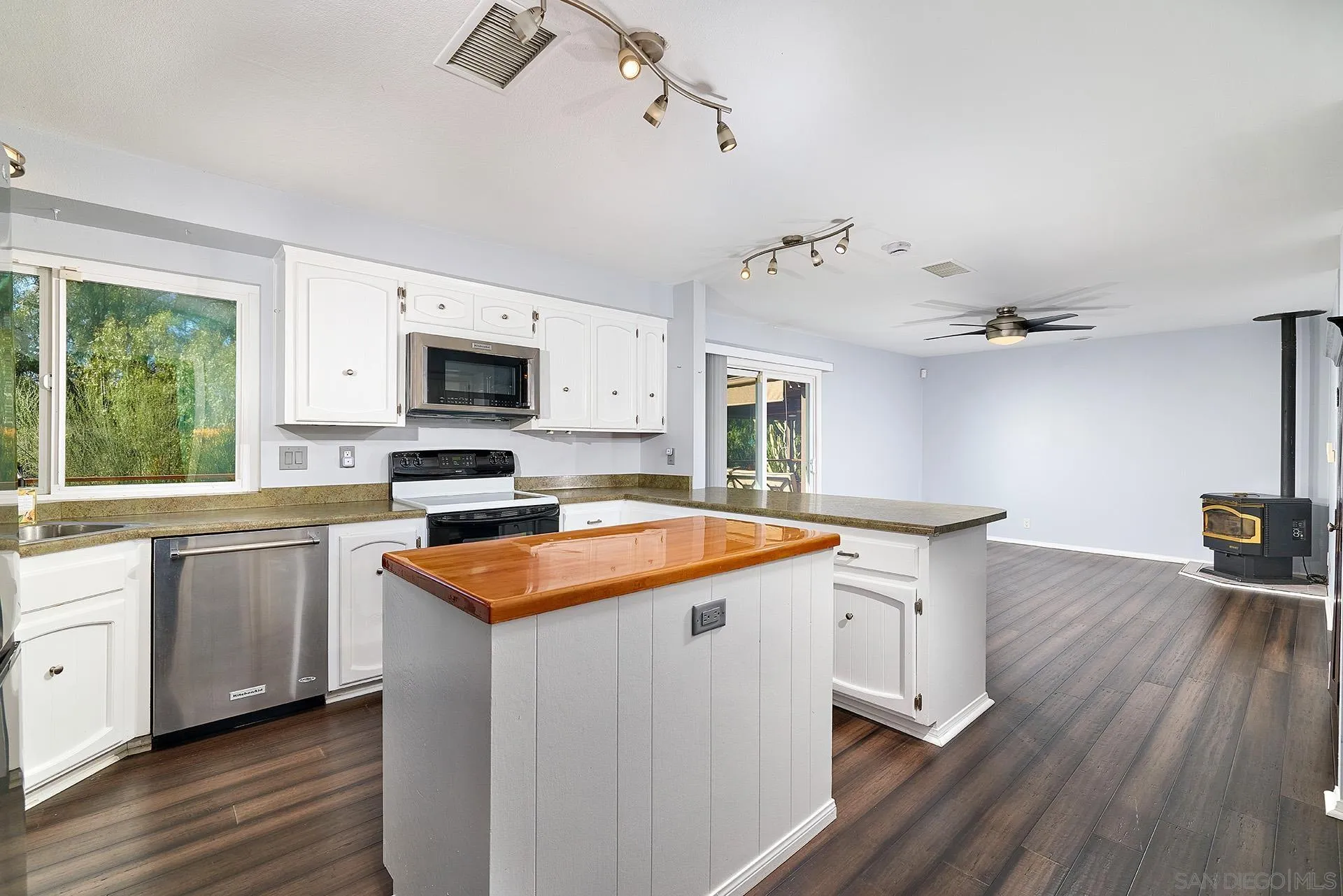 15260 Vali Hai Road Poway, CA 92064 - Photo 8 of 40 a kitchen with stainless steel appliances granite countertop a sink a stove and a wooden floors