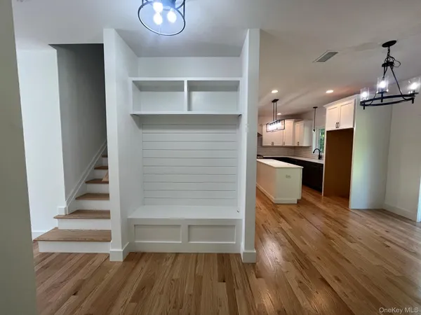 a view of a kitchen with wooden floor and electronic appliances