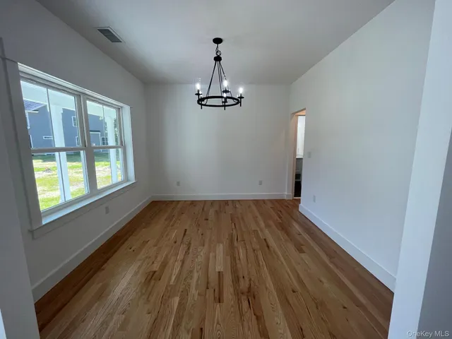a view of a room with wooden floor staircase and windows