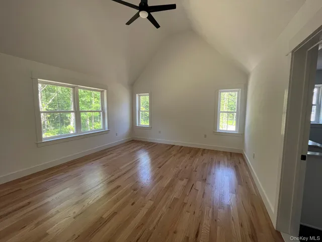 a view of a room with wooden floor and window