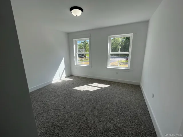 an empty room with a empty space and windows