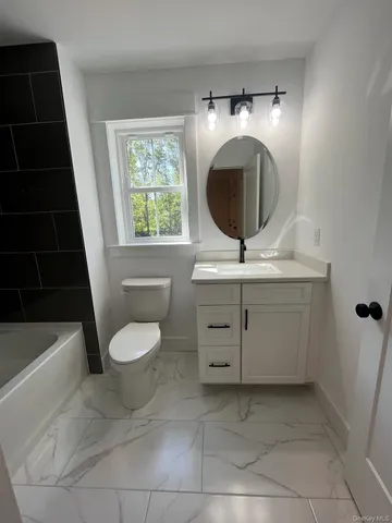 a bathroom with a toilet a sink and a bathtub