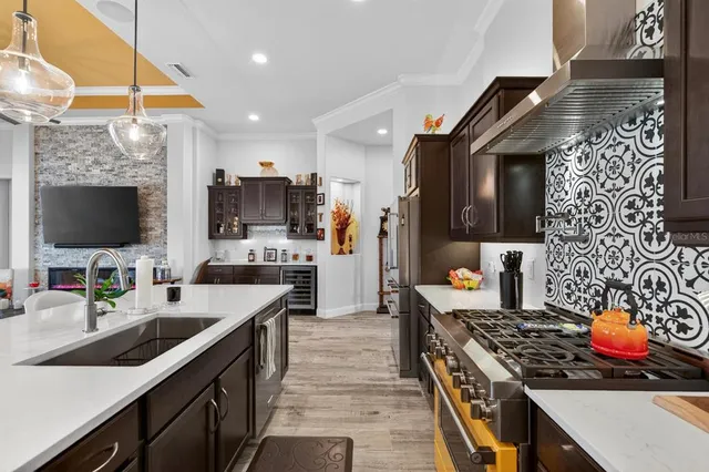 a view of a dining room with furniture and a chandelier